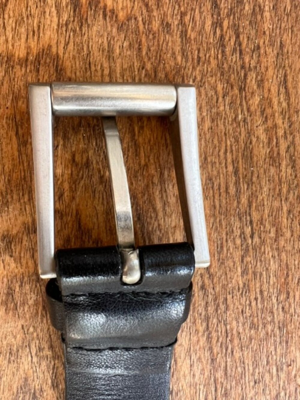 Authentic Prada black leather men’s belt with classic silver-tone buckle. Italy